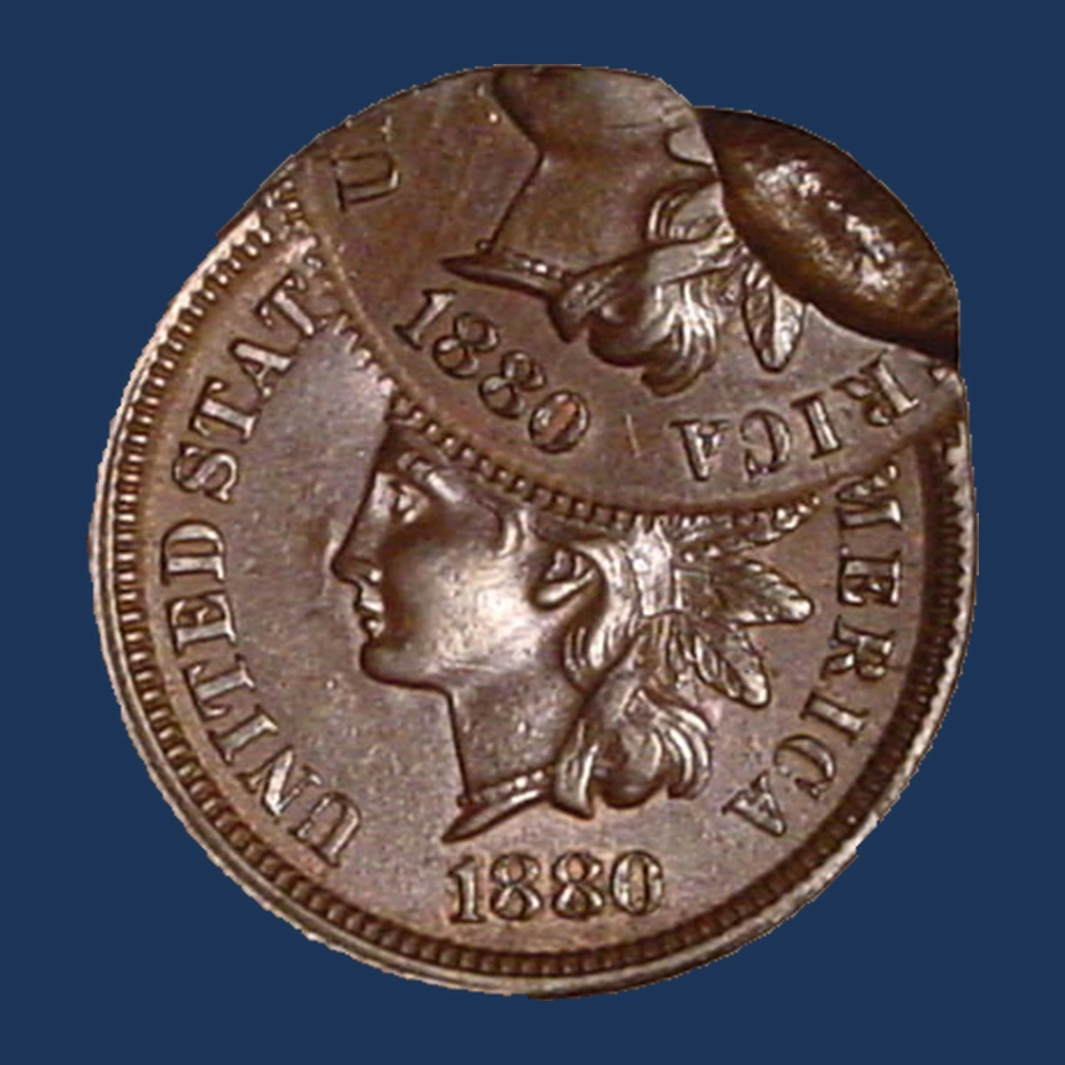 1880 Indian Head cent double struck with the second strike 55 percent off center and an indent