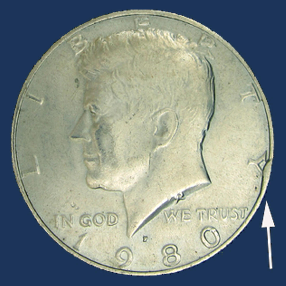 1980 Kennedy Half Dollar: obverse rim cud
